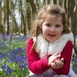 a girl around a field of flowers