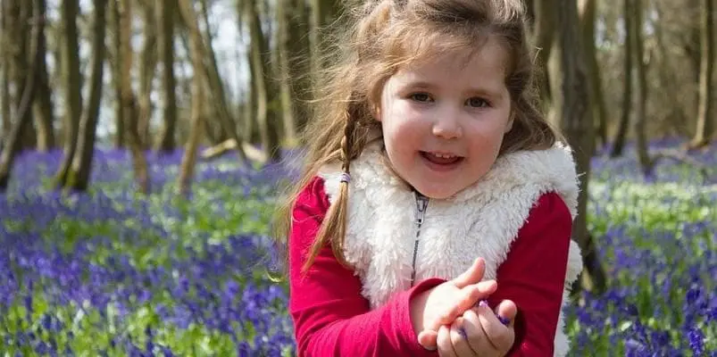 a girl around a field of flowers