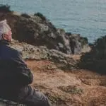 two old couple sitting at the shore