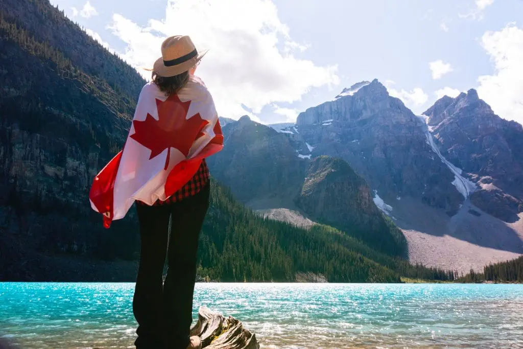 a woman draped with a Canadian flag