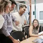 a group of employees in a meeting