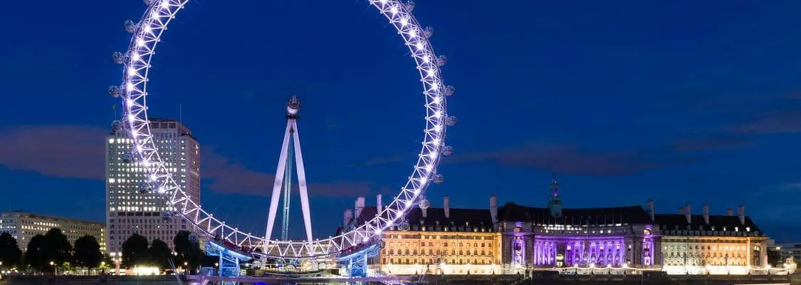 large lit-up ferris wheel against night sky