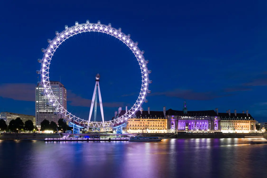 large lit-up ferris wheel against night sky