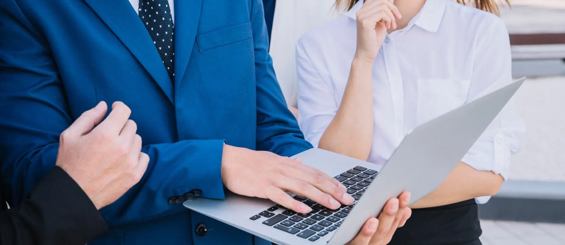 a businessman holding a laptop