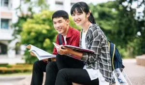 two students studying in the park