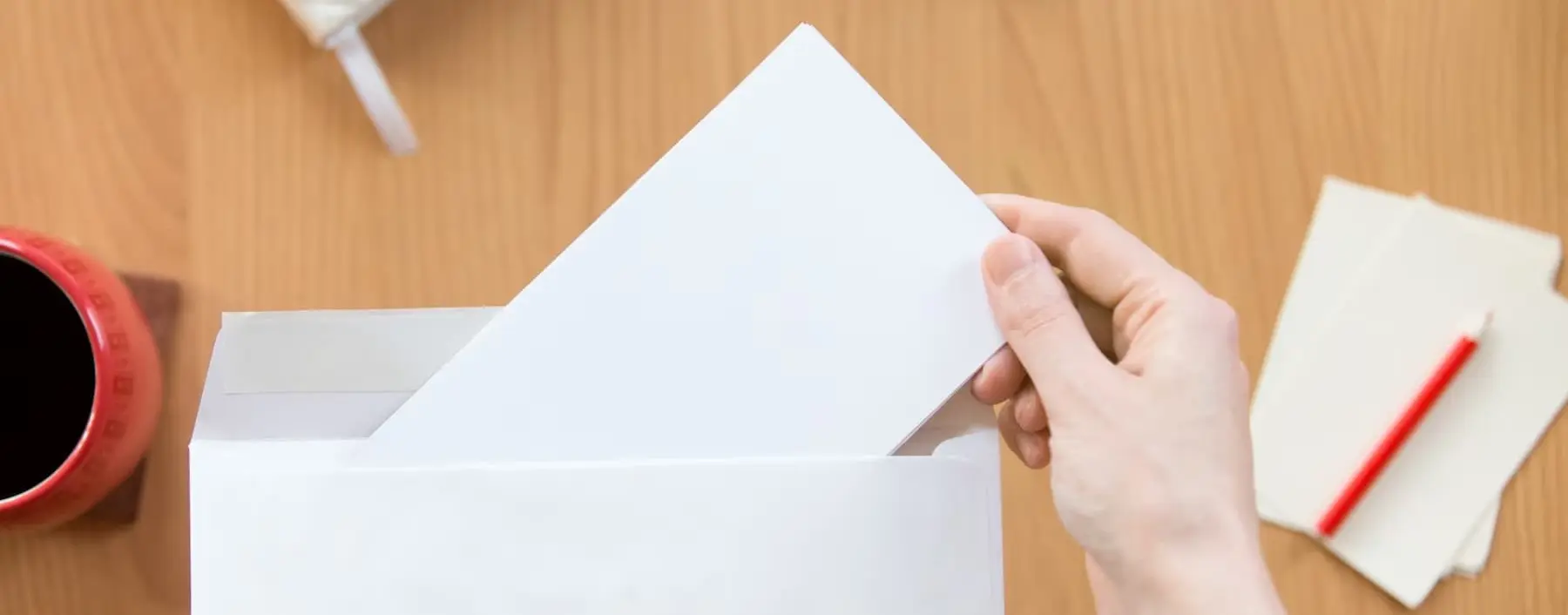 a person opening a letter