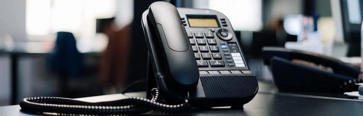 landline telephone placed on a desk in an office