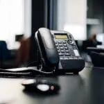 landline telephone placed on a desk in an office