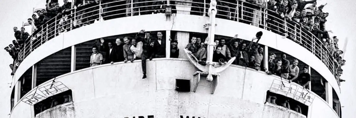 black and white photo of windrush ship with passengers visible