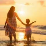 a mother and child at the beach