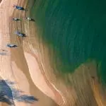 Sandy coast near azure ocean water