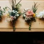 four bouquets on a wooden platform