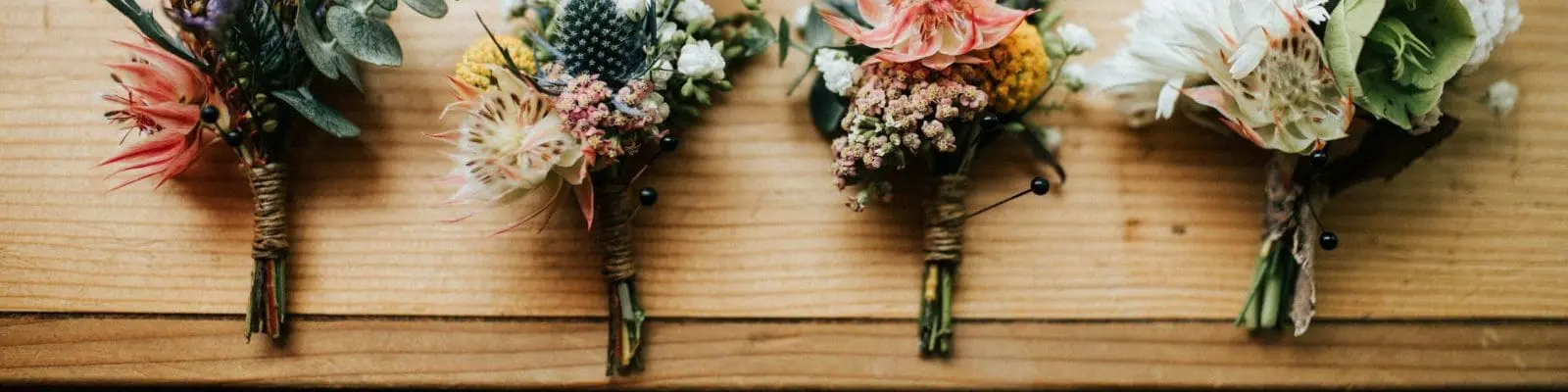 four bouquets on a wooden platform