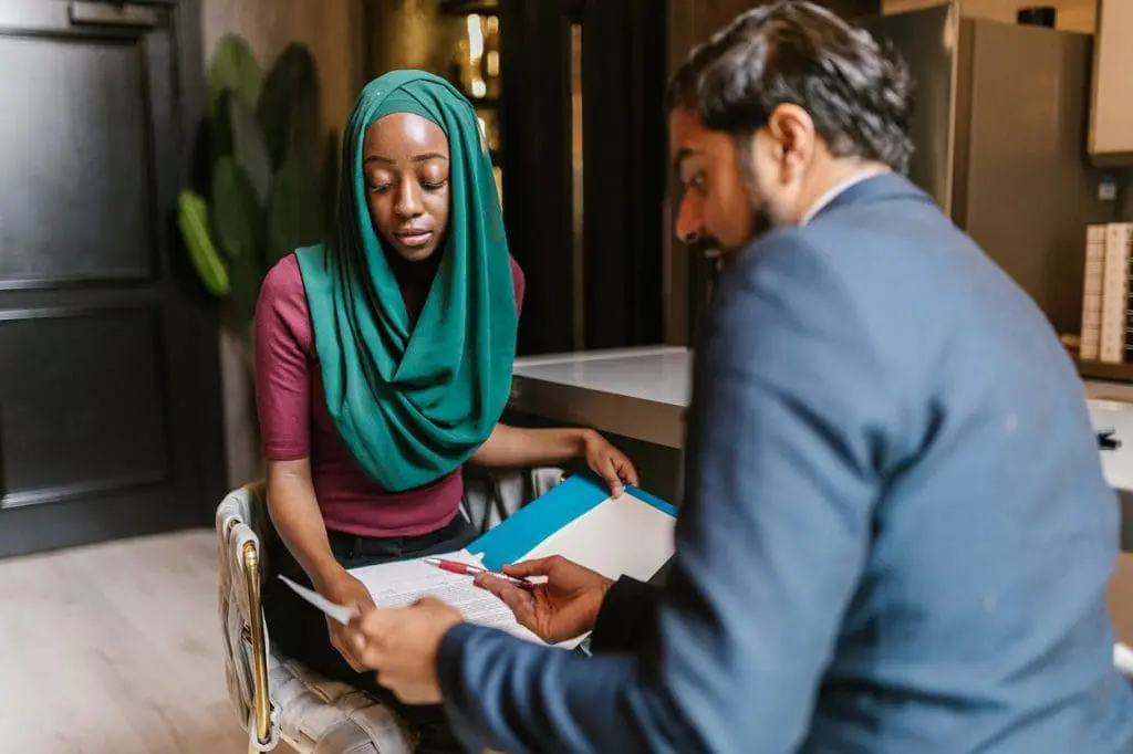 woman and man looking at documents and speaking