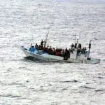 people on a boat in the middle of the sea