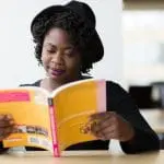 Student reading through textbook
