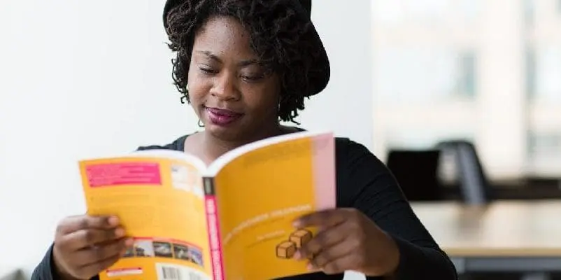 Student reading through textbook