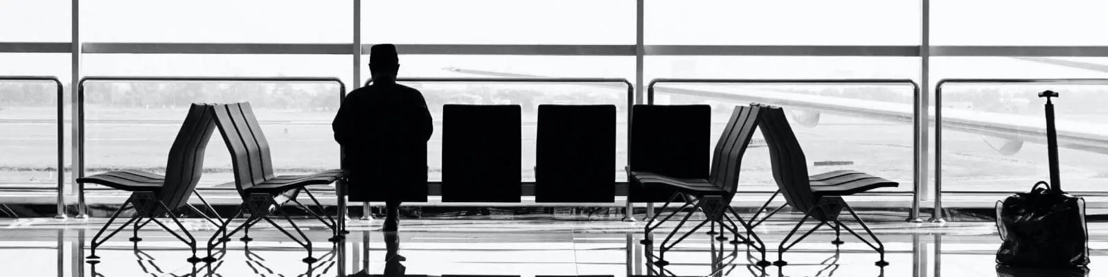 man sitting on gang chair in airport