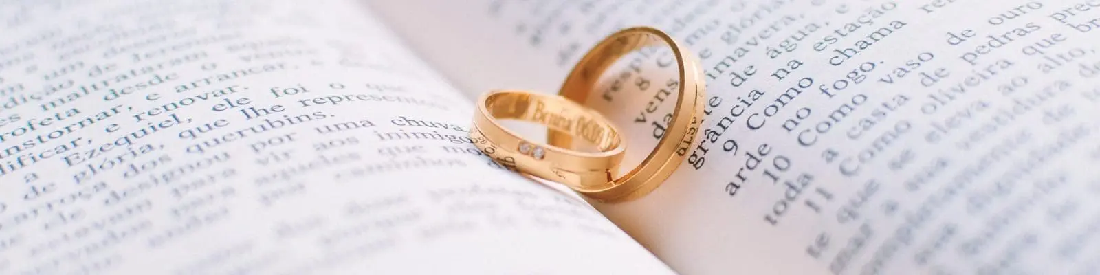 wedding rings on top of a book