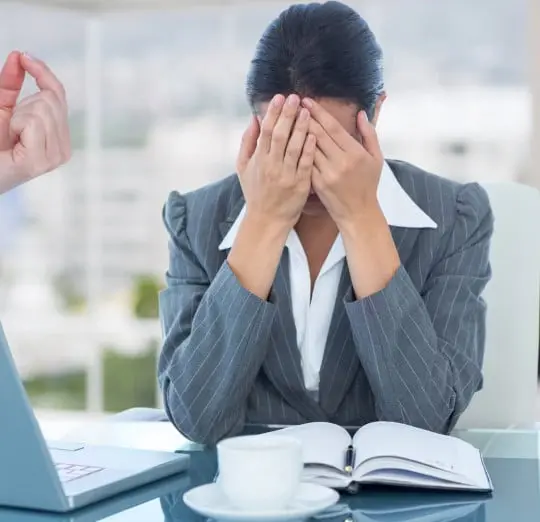 an employee covering her face with her palm