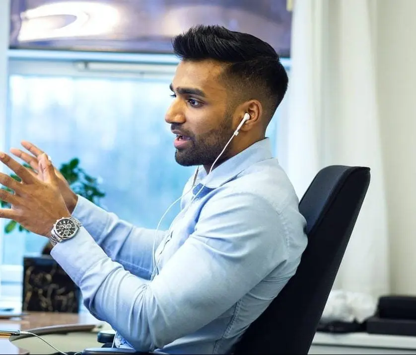 Lawyer speaking on the phone using hands free headphones.