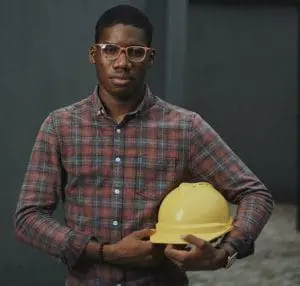 Man holding a yellow hard hat