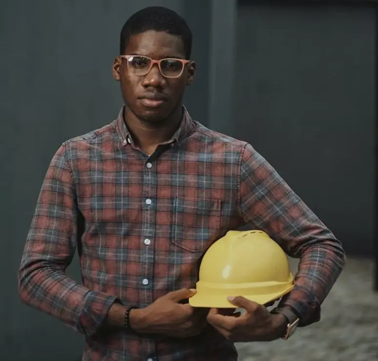 Man holding a yellow hard hat