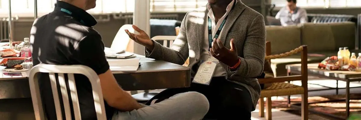 Two men sitting at table having a discussion