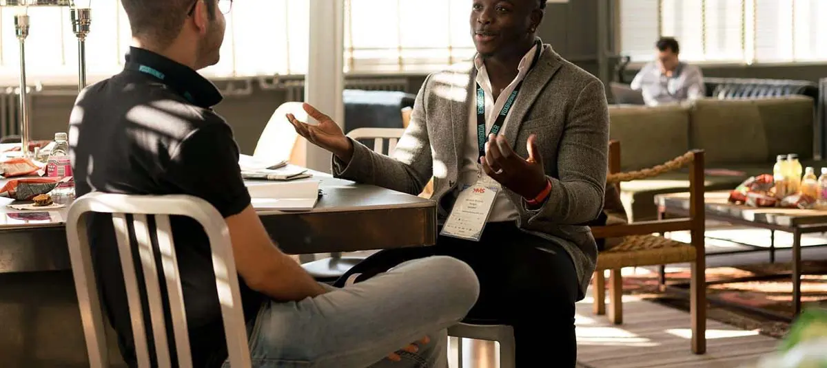 Two men sitting at table having a discussion