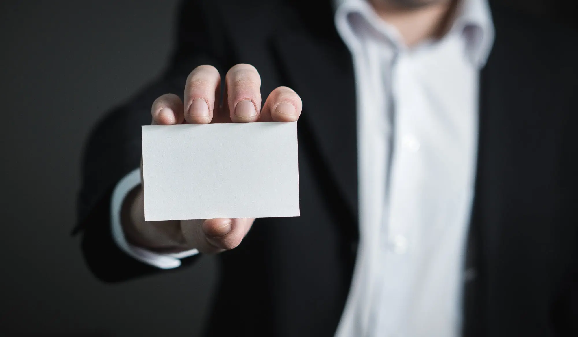 Lawyer holding up business card.