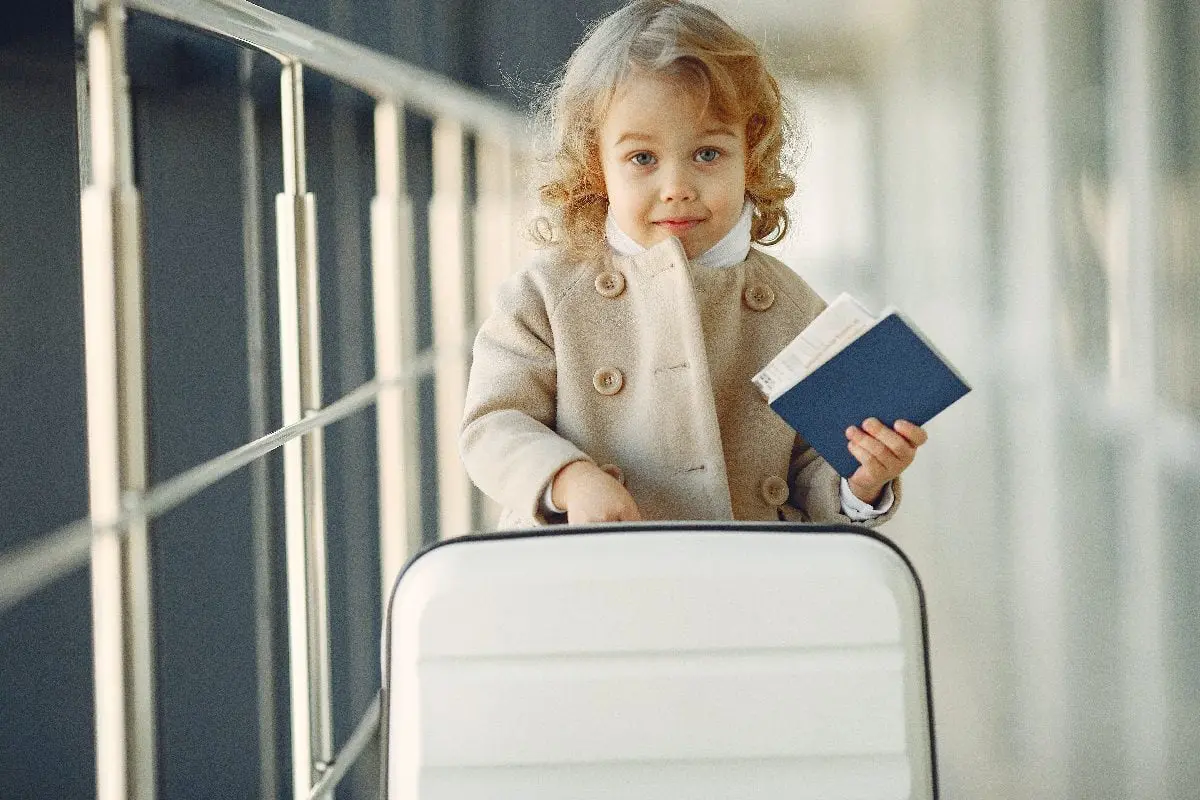 Child with suitcase and passport