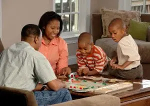 Family playing a game of Monopoly