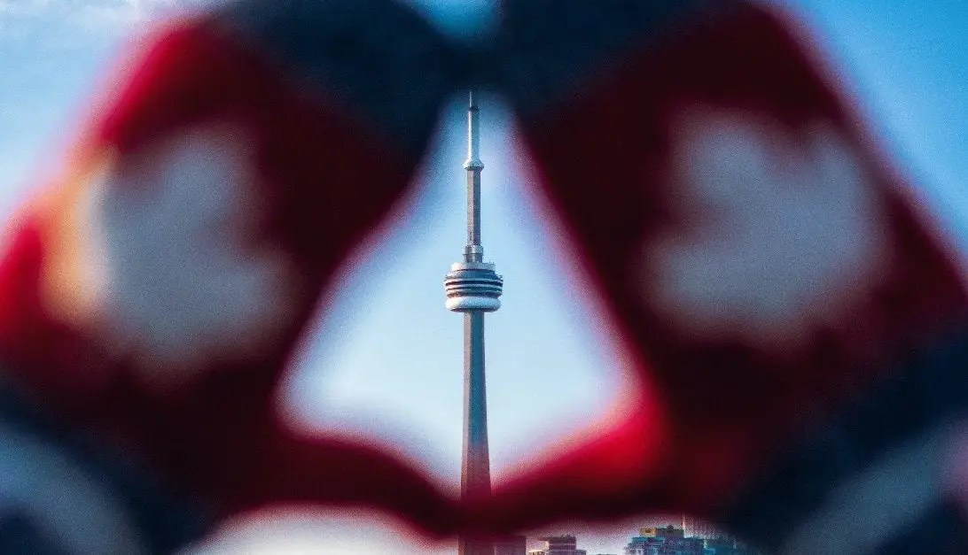 Gloved hands highlighting Canadian landmark