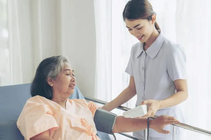 Elderly woman taking blood pressure