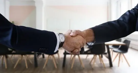 two businessman shaking hands