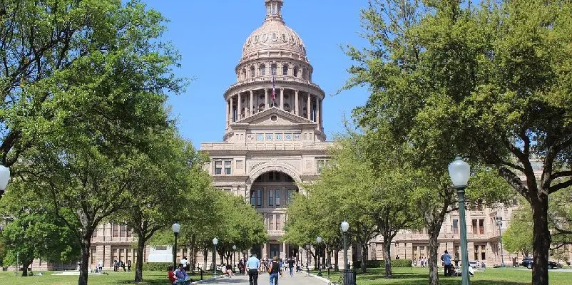 View of the US Capitol building from footpath between trees