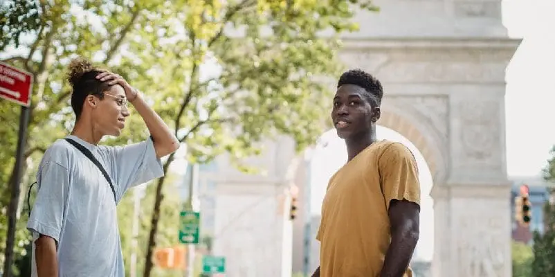 Two friends standing together on street in America