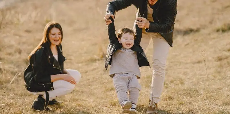 Parents playing with child, outside