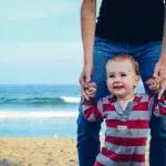 Father walking with child on the beach