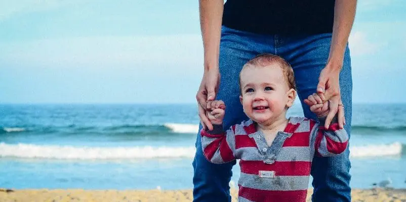 Father walking with child on the beach