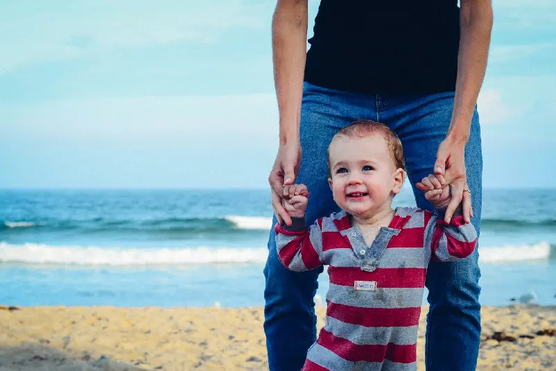 Father walking with child on the beach
