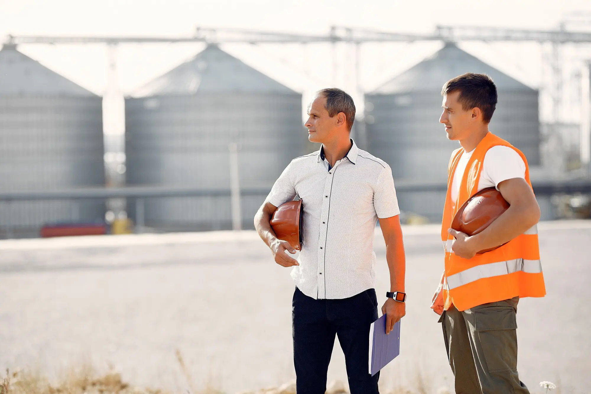 two skilled employees standing at a factory
