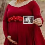 Pregnant woman holding ultrasound