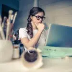 Worried woman doing research on her laptop
