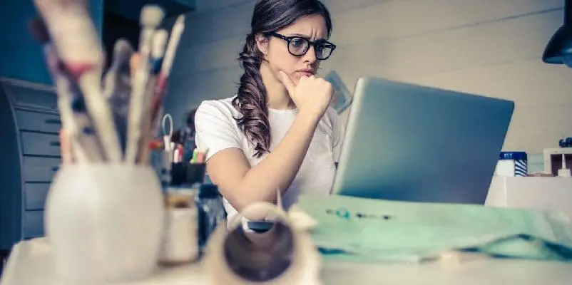 Worried woman doing research on her laptop