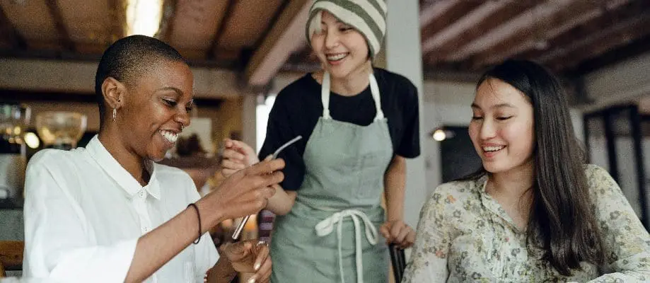 Women at a table, enjoying each other's company