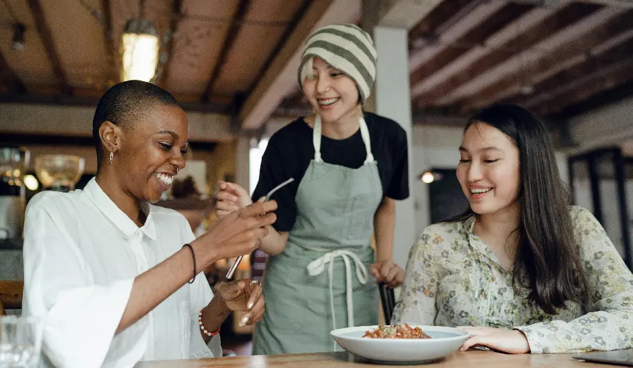 Women at a table, enjoying each other's company