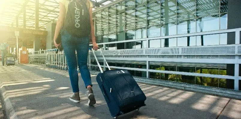Woman walking at airport with her luggage