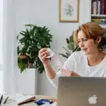 Woman looking at cost of items on a receipt