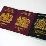 Three British passports aligned next to each other